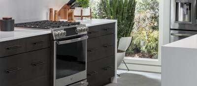 A picture perfect kitchen filled with GE IoT connected appliances, microwave, stove, refrigerator and dishwasher